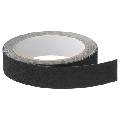 Black self-adhesive anti-slip tape roll for stair safety, made of polyethylene and quartz.
