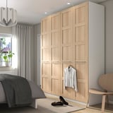 Bedroom with tall wooden PAX wardrobe, bed, window, curtains, heels, chair