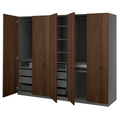 An open dark wood ikea PAX wardrobe, featuring shelves and drawers.