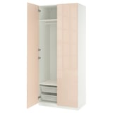A white ikea PAX wardrobe with light pink doors, one open revealing shelves and mesh baskets inside.