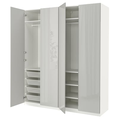 This image shows a white PAX wardrobe with open doors revealing storage sections and mesh baskets inside.