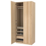 An open light brown wooden PAX wardrobe with shelves and drawers.