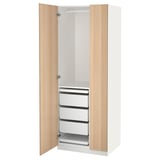 An open white PAX wardrobe with light wooden doors, featuring drawers and trays inside.