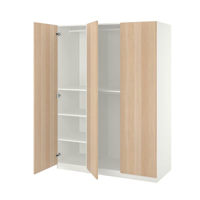 An ikea PAX wardrobe with light oak doors, three shelves, and hanging space.