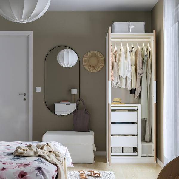 Modern bedroom with open PAX wardrobe, smart storage, and stylish decor.