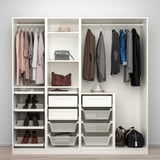 A well-organized closet with hanging clothes, shoes, bags, and storage bins, combining PAX and komplement systems.