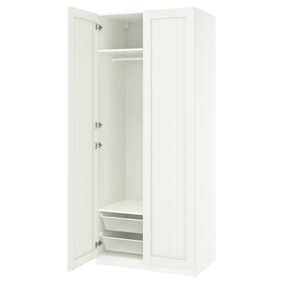 A white ikea PAX wardrobe with one door open, revealing shelves and a mesh basket.
