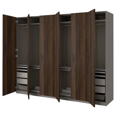 An open dark wooden wardrobe with shelves and drawers.