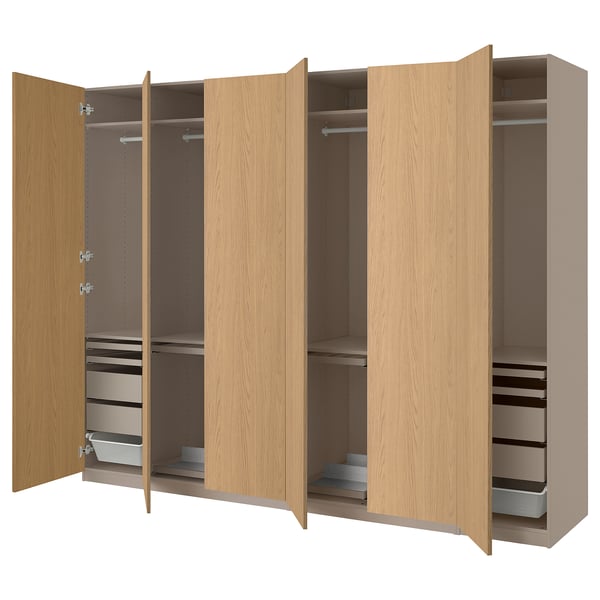 A light brown PAX wardrobe with multiple compartments and shelves for organized storage. It drawers and a hanging section.