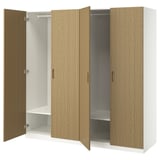 Open IKEA PAX wardrobe with wooden doors and storage shelves.