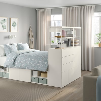 Modern white PLATSA bed with storage, large window.