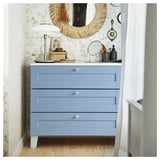 Blue PLATSA chest with drawer fronts in light wooden floor setting.