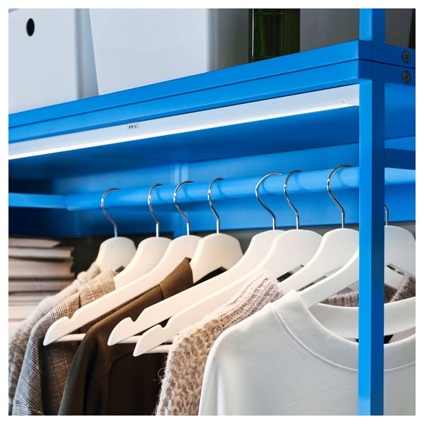 Blue PLATSA clothes rack, featuring multiple hangers holding various garments. Sleek, modern design with a narrow frame.