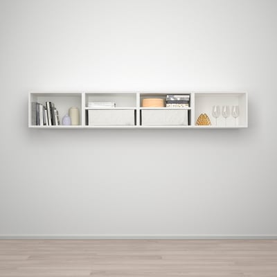 A white, modern wall-mounted shelf, PLATSA, holds books, vases, and glasses neatly on a grey wall.