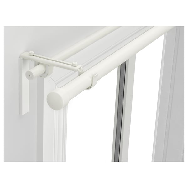 White RÄCKA curtain rod system, dual adjustable rods for layered curtains, mounted on wall near window.