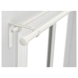 White RÄCKA curtain rod system, dual adjustable rods for layered curtains, mounted on wall near window.