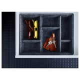 Black organizer tray with compartments, holding red and yellow sunglasses, and a keychain with keys. Made of polyester.
