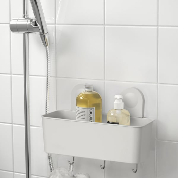 A RÅNEN bathroom organizer with suction cups, holding large shampoo and soap dispensers, plus three hooks below.
