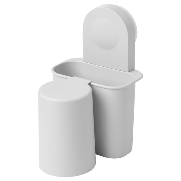 A RÅNEN toothbrush holder in white. It has a cylindrical cup and a rectangular holder with a lid, designed for wall-mounting via suction cups.