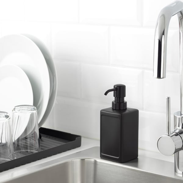 Black soap dispenser on sink edge - RINNIG series. Length: 41 characters