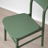 Modern green chair with smooth, rounded edges and visible wood grain, showcasing robust craftsmanship.