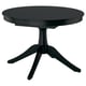 Black extendable dining table with round top and pedestal base, seats up to six.