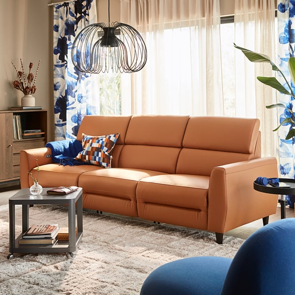 Orange RULLERUM sofa in living room, high back, blue accents, focal point.