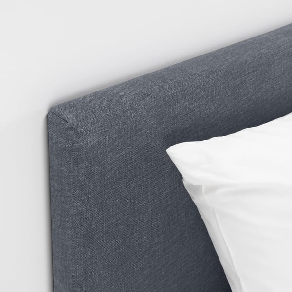 Gray fabric headboard of a modern, comfortable bed with clean lines and supportive design.