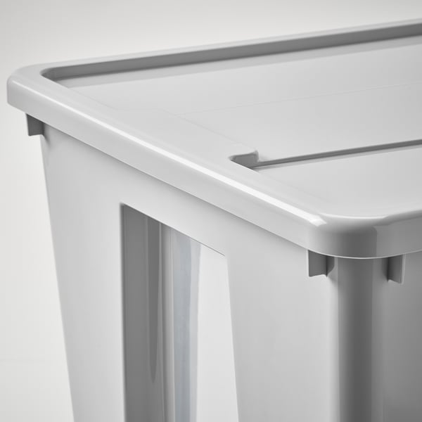 Close-up of a durable, white plastic storage box lid with secure locking mechanism.