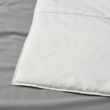 Close-up of a white duvet corner, showcasing neat, high-quality stitching and smooth, even fabric texture.