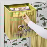 A hand pulls a decorative storage box from a shelf. The box a lion and zebra design, ideal for toy storage in a childs room.