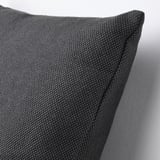 A close-up of a grey cushion with a textured cotton surface, showcasing its high-quality material and plump shape.