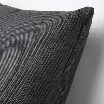 A close-up of a grey cushion with a textured cotton surface, showcasing its high-quality material and plump shape.