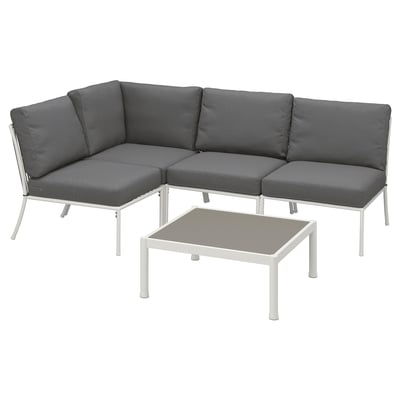 Modern outdoor sectional in dark grey, featuring a corner unit and coffee table with white metal frames.