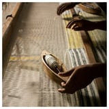 Grey wool rug with yellow accents, handwoven by artisans, soft fringes, durable, soil-resistant.