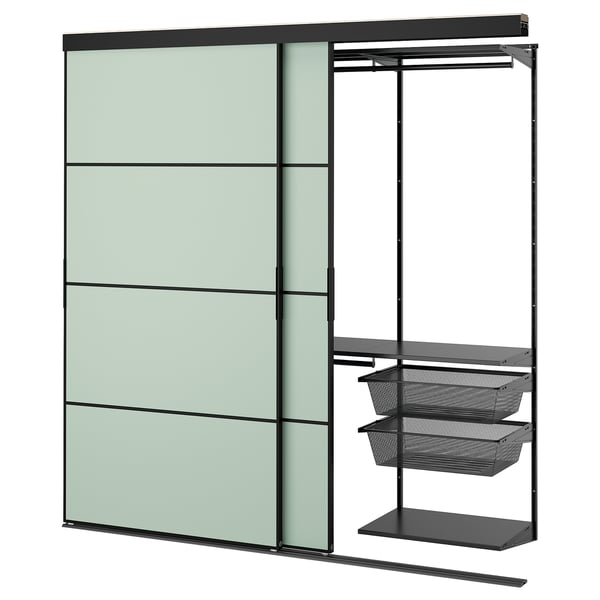 SKYTTA wall unit: green panels, black metal, sliding door, mesh shelves.