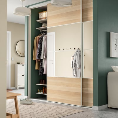Modern green room with SKYTTA wardrobe, lamp, chair, sink.