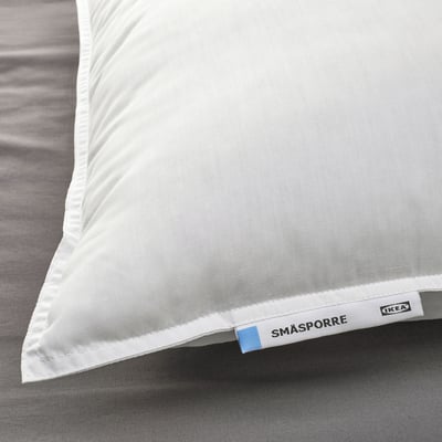 Fluffy, high-quality pillow by IKEA with smooth fabric and embroidered tag.