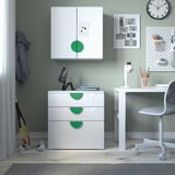Childrens room with white & green SMÅSTAD furniture, cabinet, desk, chair, clock, and toy.