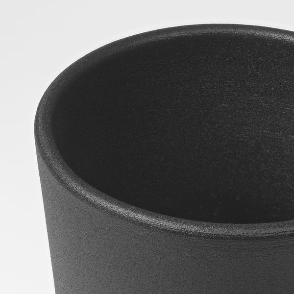 Close-up of a sleek, dark, modern plant pots smooth, coated surface.
