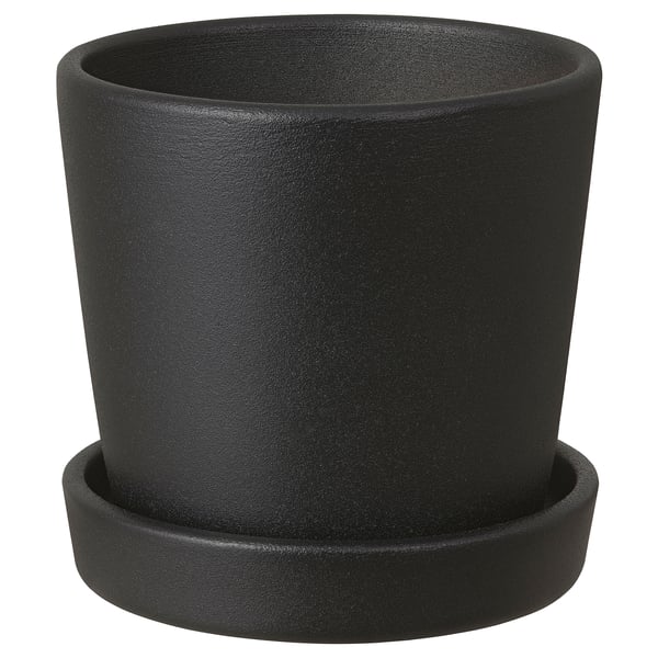 A black SMULGUBBE clay planter with a saucer. Its round, simple, and made of pigmented powder-coated red clay. Ideal for indoor or outdoor plants.