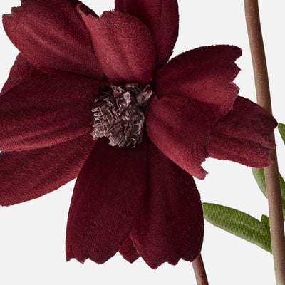 Dark red artificial flower stem with green leaves, made from recycled plastic and steel wire, lifelike design.