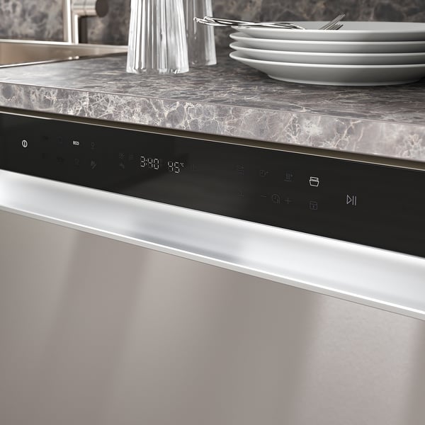 Modern dishwasher with a digital control panel and marble countertop showcasing clean dishes and cutlery.