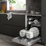Black SÖDERBODA dishwasher in modern kitchen with clean dishes, fitting under counter.