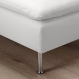 Clean, modern white sofa with deep seats and metal legs, exuding comfort and style.