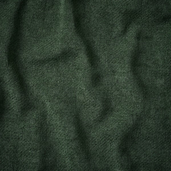 A plush green sofa with high legs and deep seats, inviting relaxation and comfort.