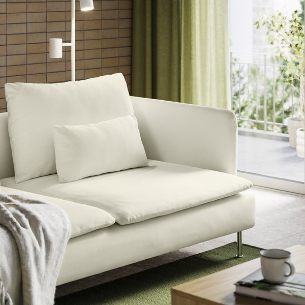 Modern white sofa SÖDERHAMN near window with blankets and mug.