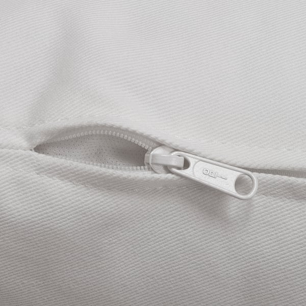 Zipper on a soft, textured white fabric, likely part of a sofa or cushion, showing a high-quality finish and sturdy pull tab.