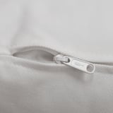 Zipper on a soft, textured white fabric, likely part of a sofa or cushion, showing a high-quality finish and sturdy pull tab.