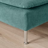 Teal cushioned chair with sleek metal leg showing sturdy design and plush texture.